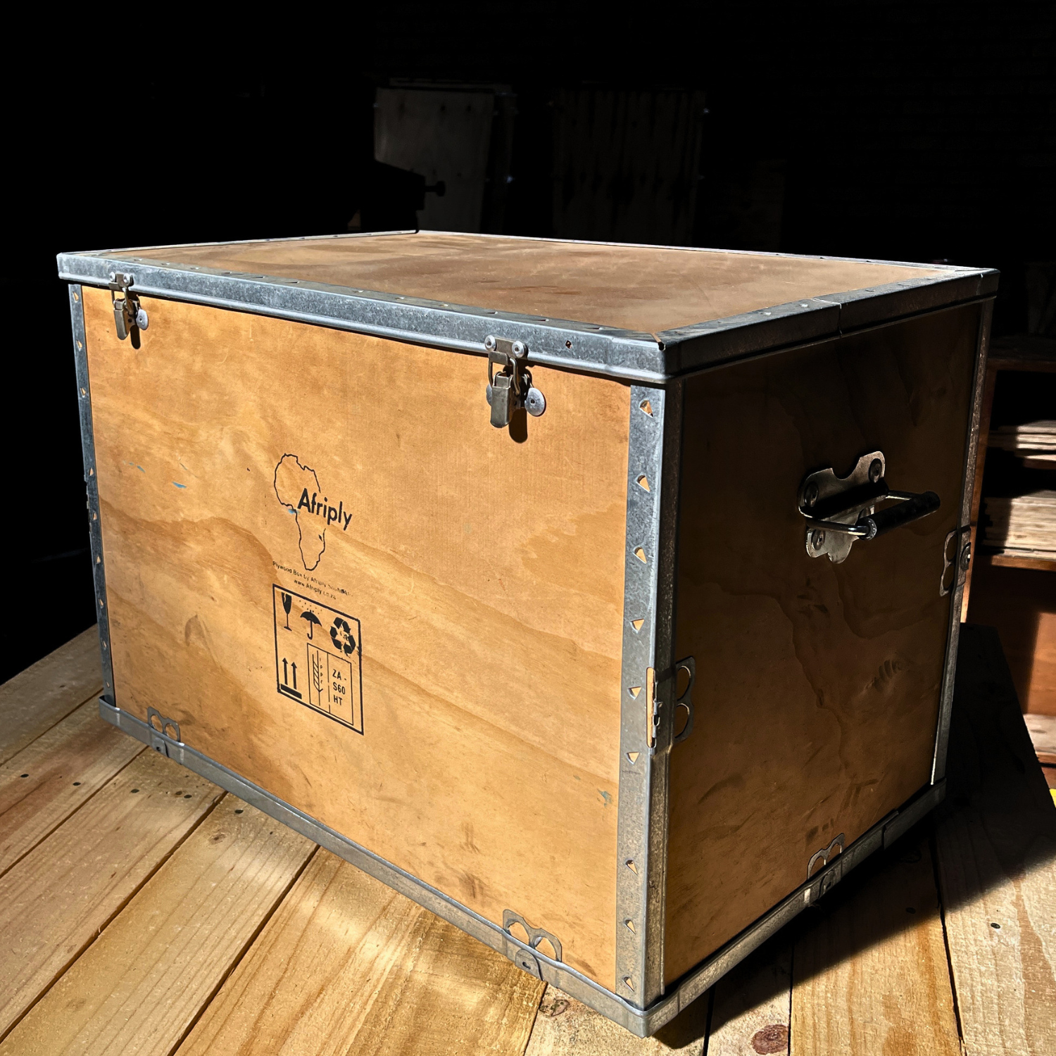 AfriPly reusable custom plywood packaging box with handles and secure latches for equipment transport.